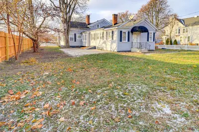 a yard with leaves on the ground in front of a house at 1 Block to Downtown Adrian Spacious Home! in Adrian