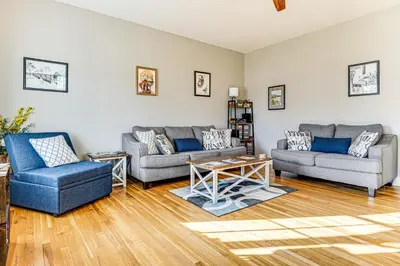 a living room with two couches and a table at East End River Retreat Dogs Welcome! in Madison