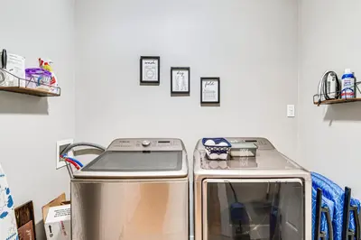 a kitchen with a stove and a white wall at East End River Retreat Dogs Welcome! in Madison