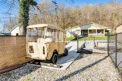 a small vehicle is parked next to a fence at East End River Retreat Dogs Welcome! in Madison