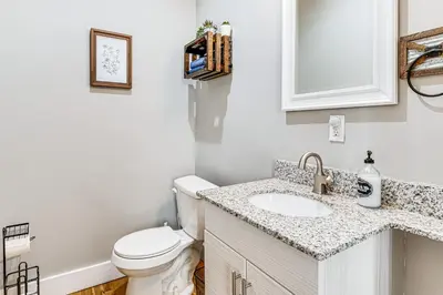 a bathroom with a toilet and a sink at East End River Retreat Dogs Welcome! in Madison