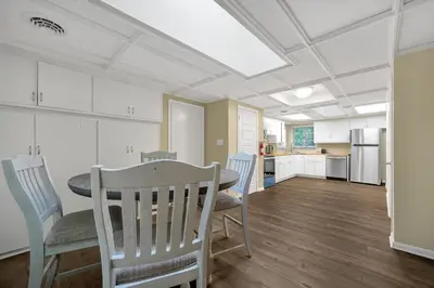 a dining room with a table and chairs and a kitchen at Tranquil Stay in Columbus in Gahanna