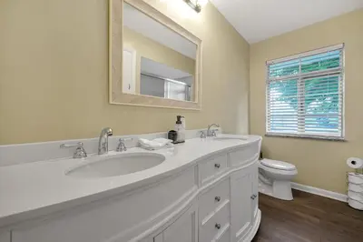 a white bathroom with a sink and a toilet at Tranquil Stay in Columbus in Gahanna