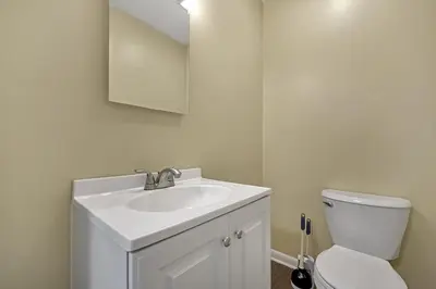 a bathroom with a white sink and a toilet at Tranquil Stay in Columbus in Gahanna