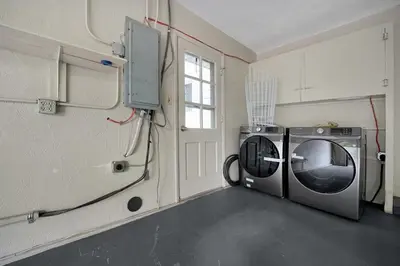 a laundry room with a washer and a washing machine at Tranquil Stay in Columbus in Gahanna