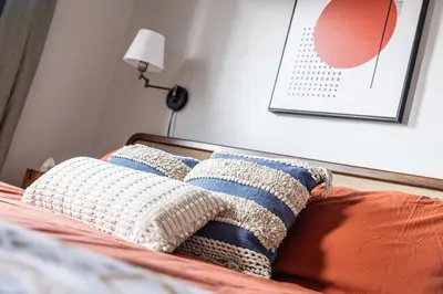 a bed with two pillows on top of it at Mid-Century Modern Retreat in Little Italy in Cleveland