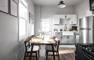 a kitchen with a table and chairs and a refrigerator at Mid-Century Modern Retreat in Little Italy in Cleveland