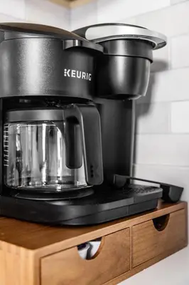 a black coffee maker sitting on top of a counter at Mid-Century Modern Retreat in Little Italy in Cleveland
