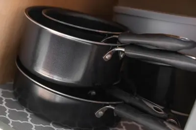 a pair of pots and pans sitting on a counter at Mid-Century Modern Retreat in Little Italy in Cleveland