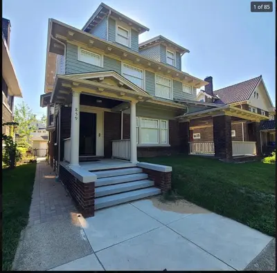 a house with a front porch with stairs in front at Beautiful Home Near Downtown & Cultural Gardens! in Cleveland