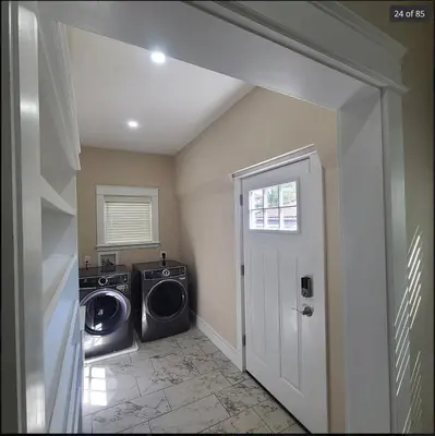 a laundry room with a washer and dryer in it at Beautiful Home Near Downtown & Cultural Gardens! in Cleveland