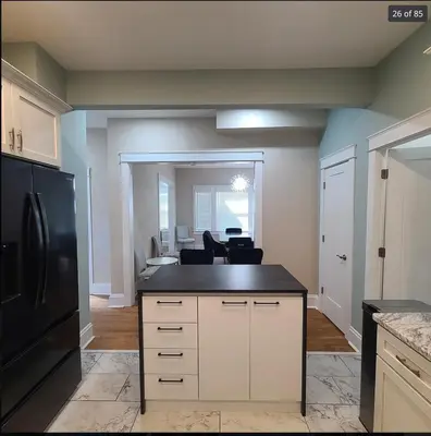 a kitchen with a black refrigerator and a counter top at Beautiful Home Near Downtown & Cultural Gardens! in Cleveland