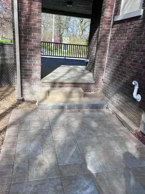 a patio with a brick wall and a bench at Beautiful Home Near Downtown & Cultural Gardens! in Cleveland