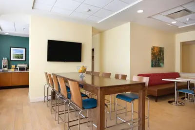 a conference room with a table and chairs and a couch at Days Inn & Suites by Wyndham Caldwell in Caldwell