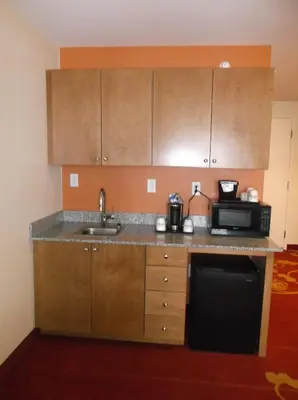 a kitchen with a sink and a microwave at Days Inn & Suites by Wyndham Caldwell in Caldwell