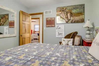 a bedroom with a bed with a horse picture on the wall at 34 Mi to Ark Encounter Kentucky Family Farmhouse in New Richmond