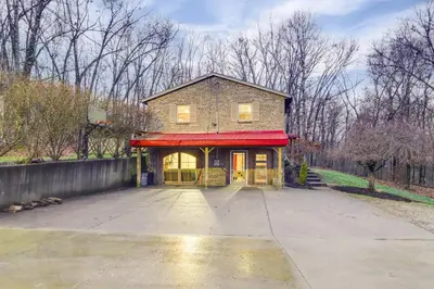 a house with a red awning on a driveway at 34 Mi to Ark Encounter Kentucky Family Farmhouse in New Richmond