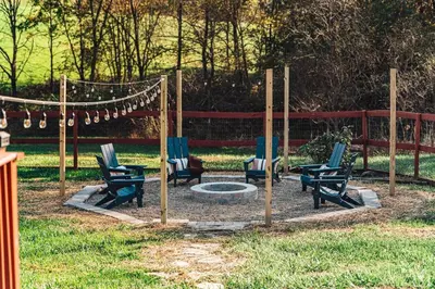 a group of chairs sitting around a fire pit at Sunset Cottage Hocking Hills in Rockbridge