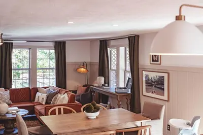 a living room with a couch and a table at Sunset Cottage Hocking Hills in Rockbridge
