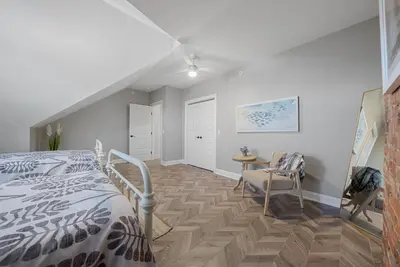 a bedroom with a bed and a table and chairs at Presidential Suite Sandusky Waterfront Area in Sandusky