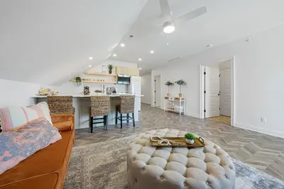 a living room with a couch and a table at Presidential Suite Sandusky Waterfront Area in Sandusky