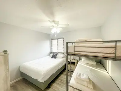 a bedroom with two bunk beds and a ceiling fan at Modern Condo Central Huron Boat Basin Area in Huron