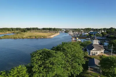 an aerial view of a river with a house at Modern Condo Central Huron Boat Basin Area in Huron