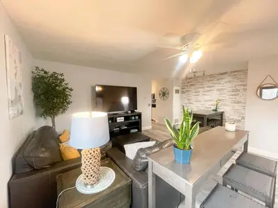 a living room with a couch and a table at Modern Condo Central Huron Boat Basin Area in Huron