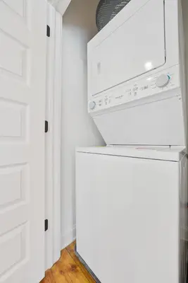 a kitchen with white cabinets and a dishwasher at Luxury Boutique Downtown Private Unit in Sandusky