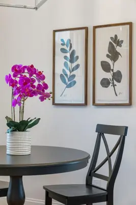 a table with a vase of purple flowers on it at Luxury Boutique Downtown Private Unit in Sandusky