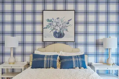 a bedroom with a bed with two lamps and a painting on the wall at Luxury Boutique Downtown Private Unit in Sandusky