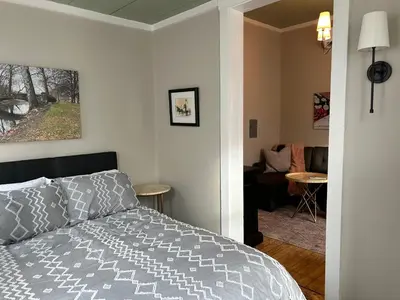 a bedroom with a bed and a living room at Davenport House in Springfield in Springfield
