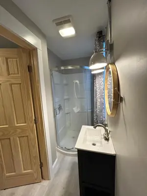 a bathroom with a shower and a sink and a mirror at Davenport House in Springfield in Springfield