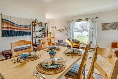 a dining room with a wooden table and chairs at 17 Mi to Brookville Lake Home with In-Unit Laundry in Connersville