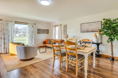 a dining room and living room with a table and chairs at 17 Mi to Brookville Lake Home with In-Unit Laundry in Connersville