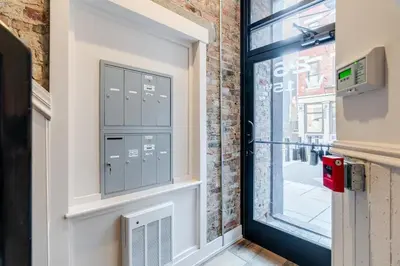 a door with a window and a brick wall at Modern Condo in the heart of Over-The-Rhine in Cincinnati