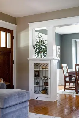 a living room with a white cabinet with glass doors at The Craftsman Uptown - Walk to Shops & Eats in Perrysburg