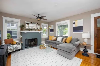 a living room with a couch and a fireplace at The Craftsman Uptown - Walk to Shops & Eats in Perrysburg