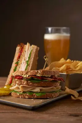 a sandwich on a plate next to a glass of beer at Hyatt Place Columbus/OSU in Columbus