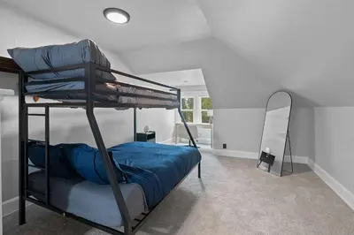 a bedroom with two bunk beds and a mirror at Minutes to Arena District - Foosball & Game Area in Columbus