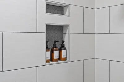 three bottles of wine in a niche in a brick wall at Minutes to Arena District - Foosball & Game Area in Columbus