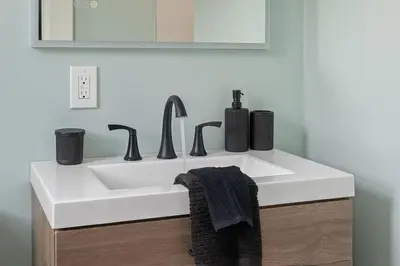 a bathroom with a white sink and a mirror at Minutes to Arena District - Foosball & Game Area in Columbus