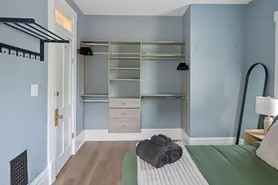 a bedroom with a bed and a closet at Minutes to Arena District - Foosball & Game Area in Columbus