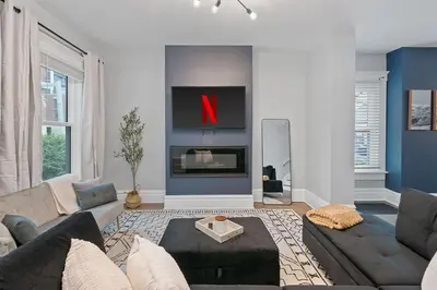 a living room with a couch and a fireplace at Minutes to Arena District - Foosball & Game Area in Columbus