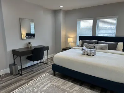 a bedroom with a bed and a desk and a table at Lovely 2BR Near Downtown Area in Columbus