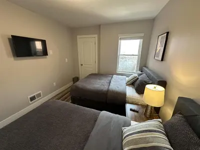 a living room with two beds and a couch at Lovely 2BR Near Downtown Area in Columbus
