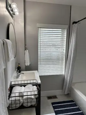 a bathroom with a sink and a tub and a window at Lovely 2BR Near Downtown Area in Columbus