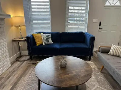 a living room with a blue couch and a coffee table at Lovely 2BR Near Downtown Area in Columbus