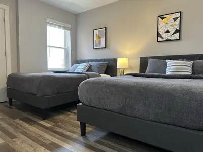 a bedroom with two beds and a couch at Lovely 2BR Near Downtown Area in Columbus