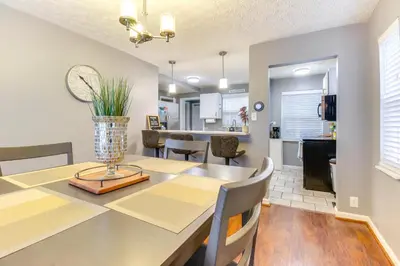 a dining room and kitchen with a table and chairs at Walk to Main Street Charming Bellevue Home in Bellevue